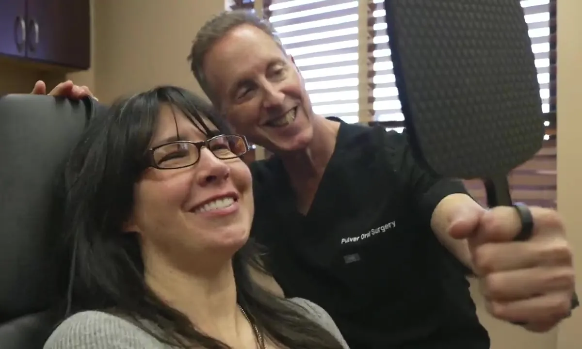 A patient sees her new smile for the first time with Dr. Pulver